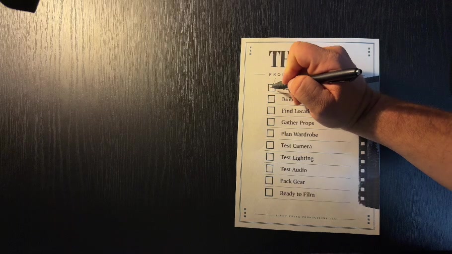 A hand marking a preparation checklist for The Call, with tasks for wardrobe, camera, lighting, audio and gear